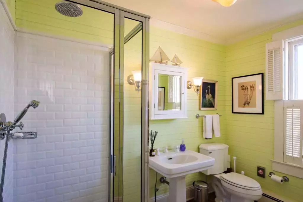 Chadwick Cottage Vacation Rental Home. Rear bathroom with bead board walls, vintage pedestal sink and shower with subway tile. Vacation Rentals Asbury Park. Vacation Rentals Ocean Grove. Chadwick Cottage Vacation Rental Home. Rear bathroom with bead board walls, vintage pedestal sink and shower with subway tile. Vacation Rentals Asbury Park. Vacation Rentals Ocean Grove. - Chadwick Cottage Vacation Rental Home - Ocean Grove