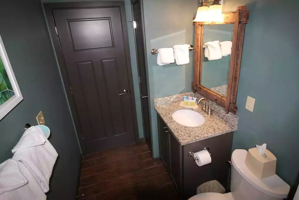 The guest bath includes granite countertops and vanity storage. The bathroom floors have a beautiful ceramic tile floor that looks like hardwood. Towels and wash cloths, hair dryer, soap, lotion, shampoo and conditioner included. Just lovely! The guest bath includes granite countertops and vanity storage. The bathroom floors have a beautiful ceramic tile floor that looks like hardwood. Towels and wash cloths, hair dryer, soap, lotion, shampoo and conditioner included. Just lovely! - Entire Cabin 1 Wisc Dells 3 Beds(2Bedrooms) 2Baths - 63 Christmas Mountain Road