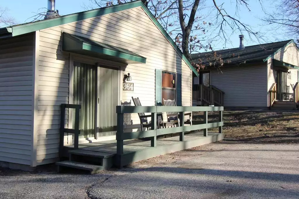 All cottages have a porch with two rocking chairs, small table. Cottage may be individual or duplex style. Cottage shown is individual. Located on 800 acres there are lots of trees and lots of great views! All cottages have a porch with two rocking chairs, small table. Cottage may be individual or duplex style. Cottage shown is individual. Located on 800 acres there are lots of trees and lots of great views! - Entire Cottage 1 Wisc Dells 2 Bed 1 Bath Sleeps 6 - Wisconsin Dells