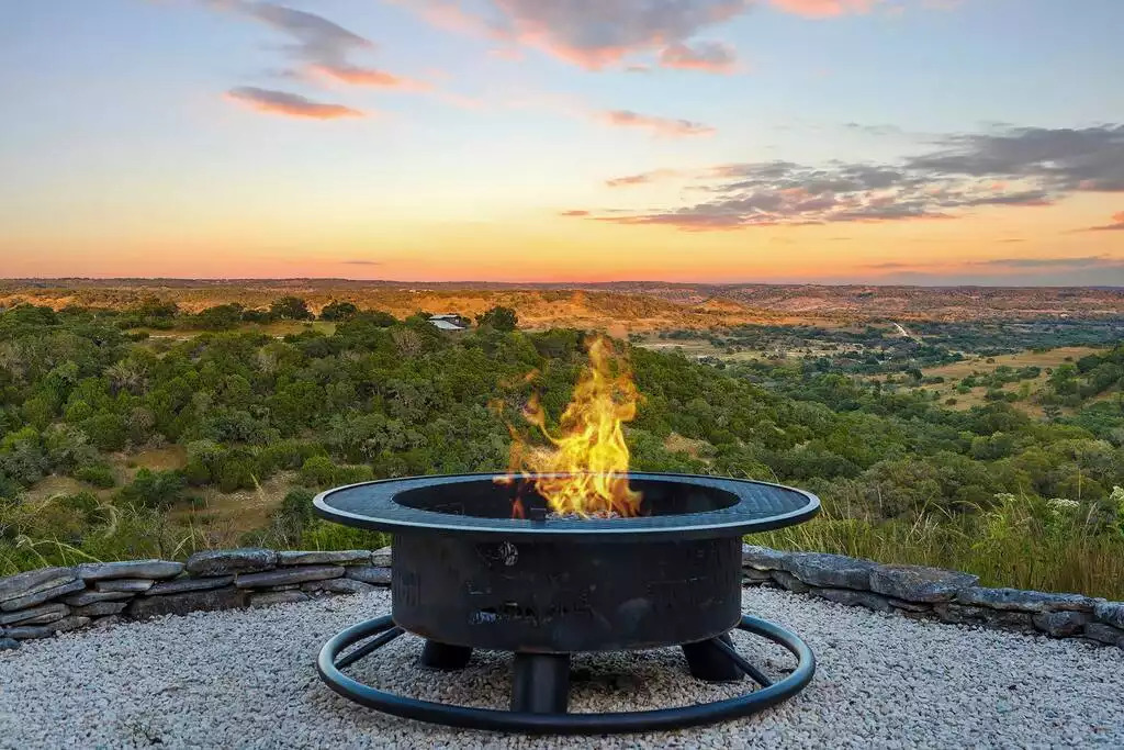 Fire pit overlooking the view of the valley. Please no fires if wind is over 10 mph/put out flames before retiring for the evening. Firewood is provided. There are 8 adirondack chairs for seating around the fire pit. We also have throw blankets.