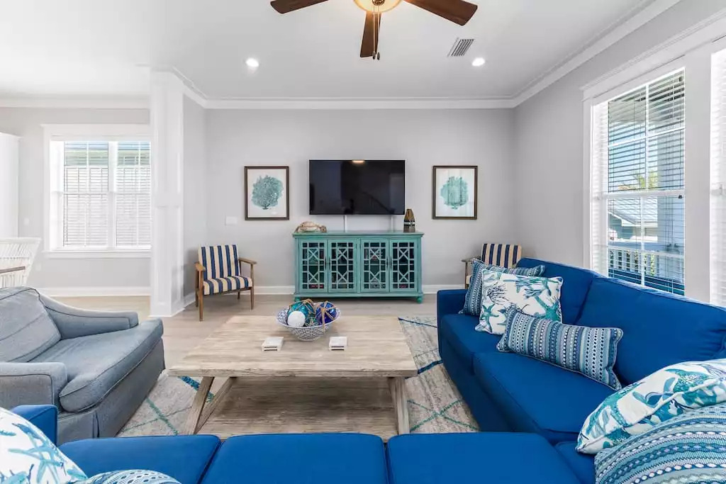 Guests can relax in the living room area that comfortably seats up to 12. Guests can enjoy conversation, take in the beautiful patio and back yard view or watch the 65” Smart TV & DVD player. The nautical design reminds you the beach is near! Guests can relax in the living room area that comfortably seats up to 12. Guests can enjoy conversation, take in the beautiful patio and back yard view or watch the 65” Smart TV & DVD player. The nautical design reminds you the beach is near! - Shipwrecked Beach House Orange Beach, Alabama - Orange Beach