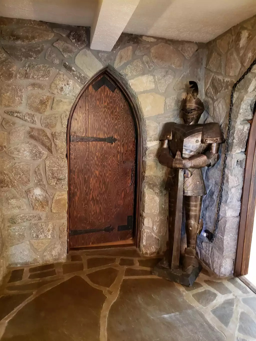 A knight stands watch over the entrance to the King bedroom A knight stands watch over the entrance to the King bedroom - Leaping Fawn Lodge - Waynesville