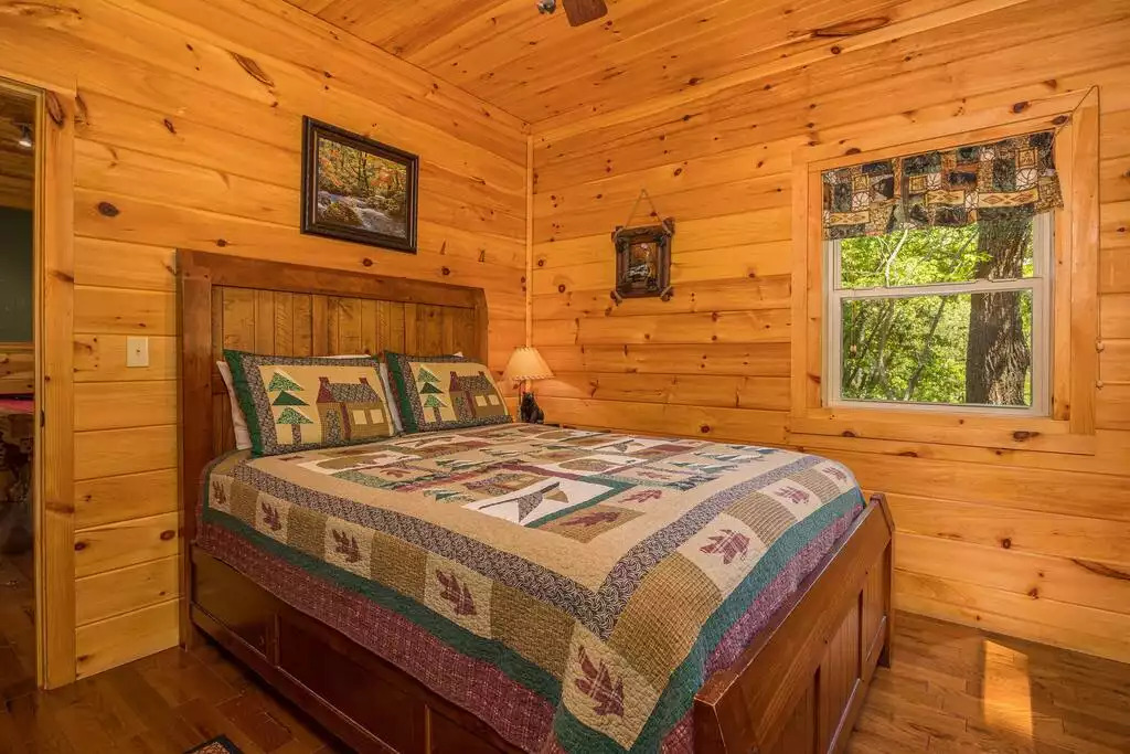 Lower Level Bedroom w/queen size bed and full bathroom Lower Level Bedroom w/queen size bed and full bathroom - Secluded Luxury 2 Bdrm Cabin w/Theatre Room & Pond - Sevierville