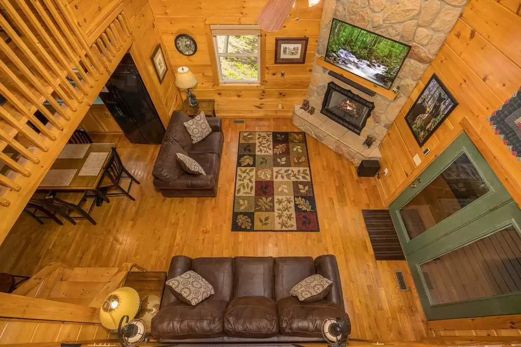 View from loft overlooking living room View from loft overlooking living room - Secluded Luxury 2 Bdrm Cabin w/Theatre Room & Pond - Sevierville