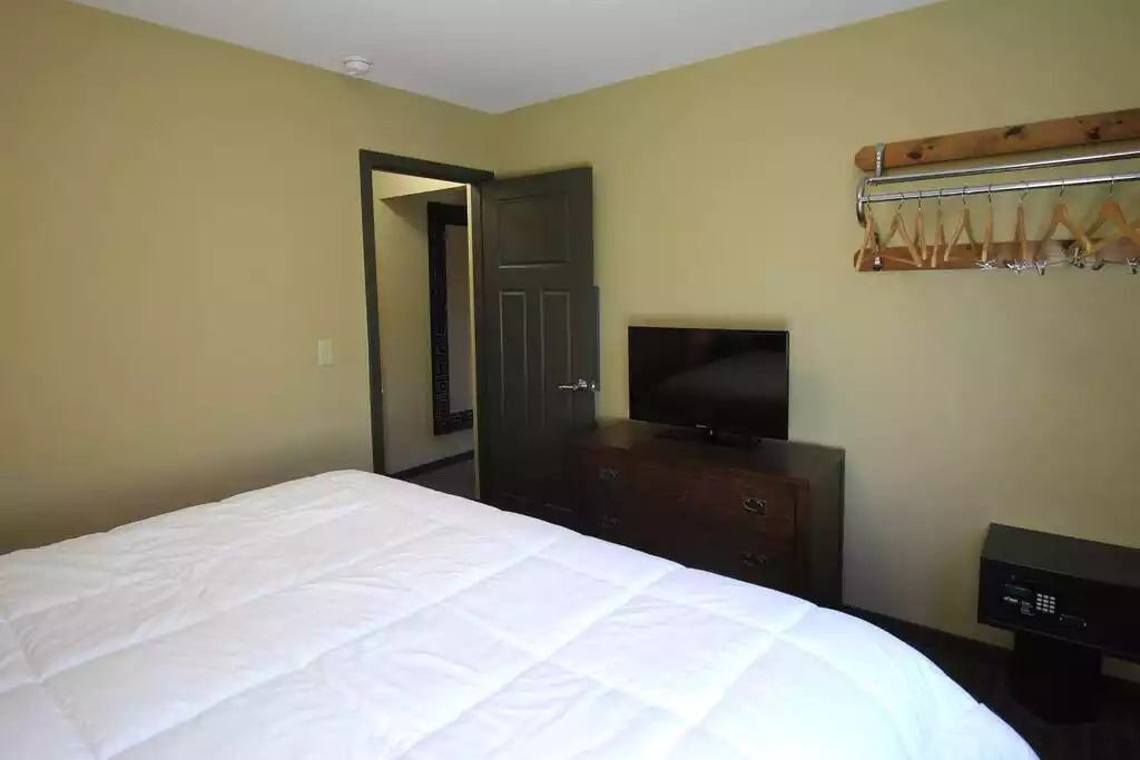 Master bedroom is spacious! With a smart TV, and free cable in every bedroom plus the living room, each person can find what suits them on TV. Free WiFi throughout the resort also allows for you to keep in touch with family or work as needed! Master bedroom is spacious! With a smart TV, and free cable in every bedroom plus the living room, each person can find what suits them on TV. Free WiFi throughout the resort also allows for you to keep in touch with family or work as needed! - Entire Cottage 1 Wisc Dells 2 Bed 1 Bath Sleeps 6 - Wisconsin Dells