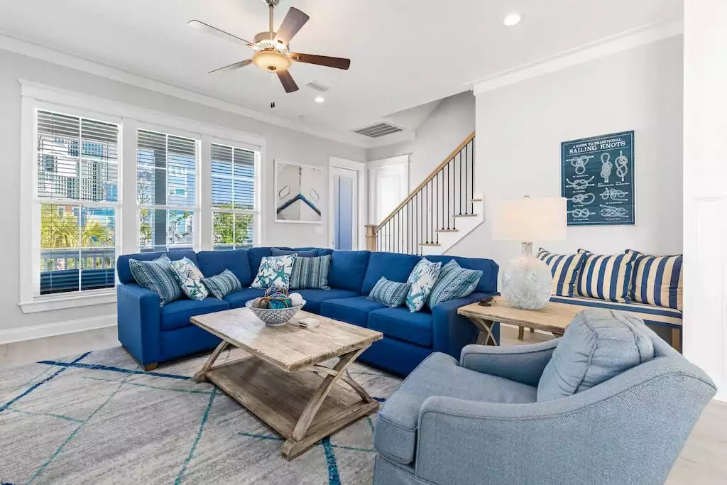 The living room has a nautical beach theme design in a comfortable, roomy setting for seating up to 12. The back windows also provide a view of the back porch & private back yard. The sofa also provides additional sleeping on the queen sleeper bed. The living room has a nautical beach theme design in a comfortable, roomy setting for seating up to 12. The back windows also provide a view of the back porch & private back yard. The sofa also provides additional sleeping on the queen sleeper bed. - Shipwrecked Beach House Orange Beach, Alabama - Orange Beach