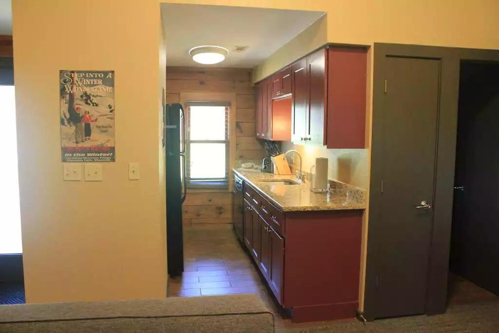 A full, galley style kitchen, including full sized refrigerator with ice maker, full sized stove/oven and microwave. This well equipped kitchen is fully stocked with dishes, glasses, dish soap, towels, salt/pepper, popcorn and coffee for your stay. A full, galley style kitchen, including full sized refrigerator with ice maker, full sized stove/oven and microwave. This well equipped kitchen is fully stocked with dishes, glasses, dish soap, towels, salt/pepper, popcorn and coffee for your stay. - Entire Cabin 1 Wisc Dells 3 Beds(2Bedrooms) 2Baths - 63 Christmas Mountain Road