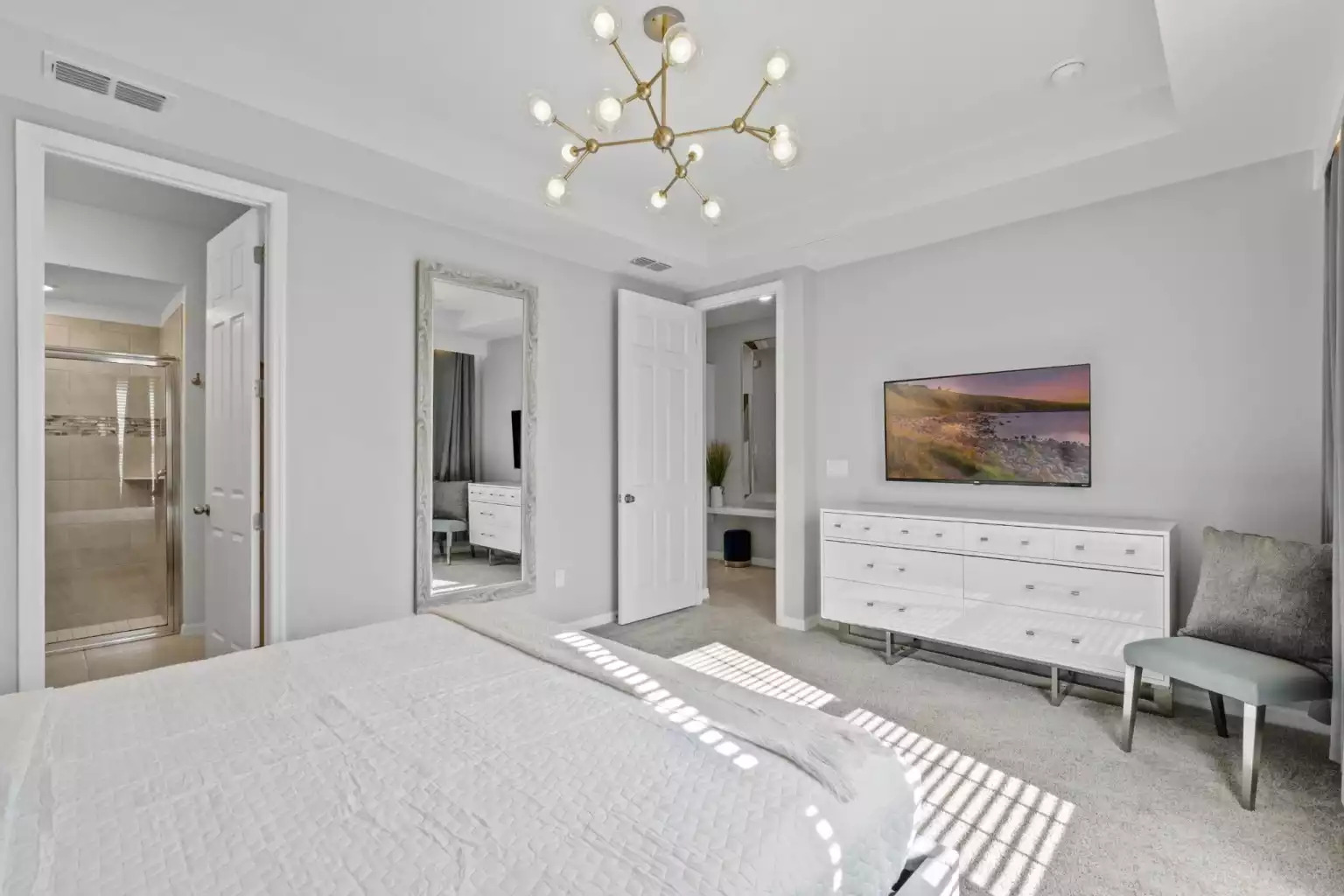 Master bedroom with king bed, bathroom with shower, closet and smart tv. Master bedroom with king bed, bathroom with shower, closet and smart tv. - Luxury Vacation Home Minutes From Disney World - Kissimmee