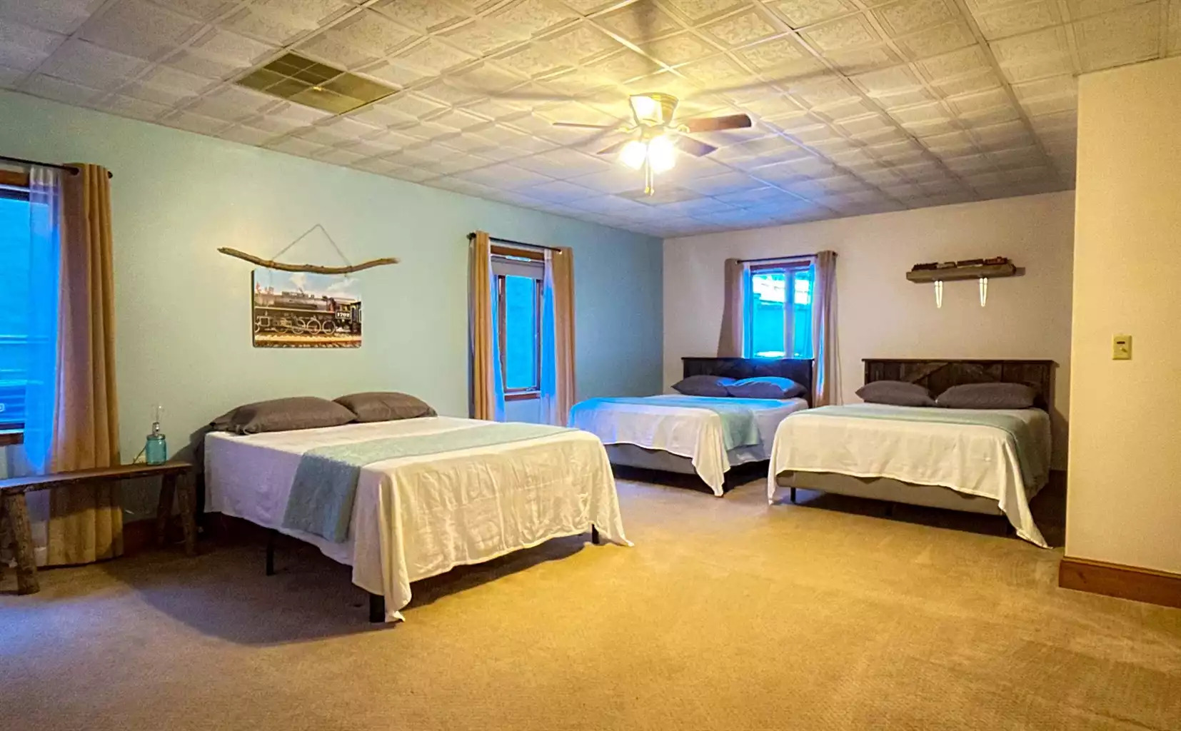 The Great Smoky Mountain Railroad bedroom is a very large a spacious room...even with 3 queen beds. This room is best utilized for the kiddos:) The Great Smoky Mountain Railroad bedroom is a very large a spacious room...even with 3 queen beds. This room is best utilized for the kiddos:) - The Hive Lodge - Whittier
