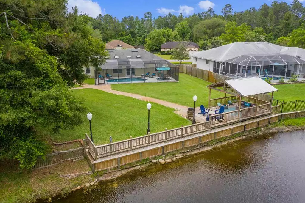 Aerial view of the house and backyard overlooking the lake. Aerial view of the house and backyard overlooking the lake. - Heated Saltwater Pool*Harry Potter*Fire Pit*BBQ*EV - St. Augustine