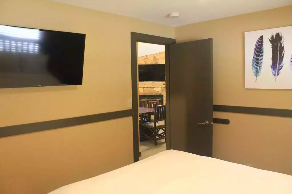 This bedroom contains a queen bed, walk in closet, a safe to protect your valuables, and a TV mounted on wall with cable. Bedroom also includes clock radio. This bedroom contains a queen bed, walk in closet, a safe to protect your valuables, and a TV mounted on wall with cable. Bedroom also includes clock radio. - Entire Cabin 3 Wisc Dells 3 Beds(2Bedrooms) 2Baths - Wisconsin Dells