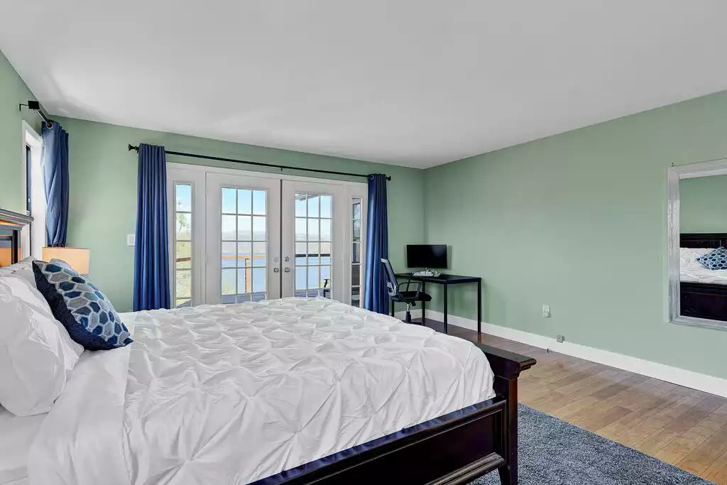 Primary (master) bedroom with King Bed, dedicated computer desk/chair, private bath, walk-in closet, access to wrap around deck and a splendid view of the Clear Lake and MT. Konocti. Primary (master) bedroom with King Bed, dedicated computer desk/chair, private bath, walk-in closet, access to wrap around deck and a splendid view of the Clear Lake and MT. Konocti. - NEW Unobstructed Lake/Mountain View home, movie rm - Kelseyville