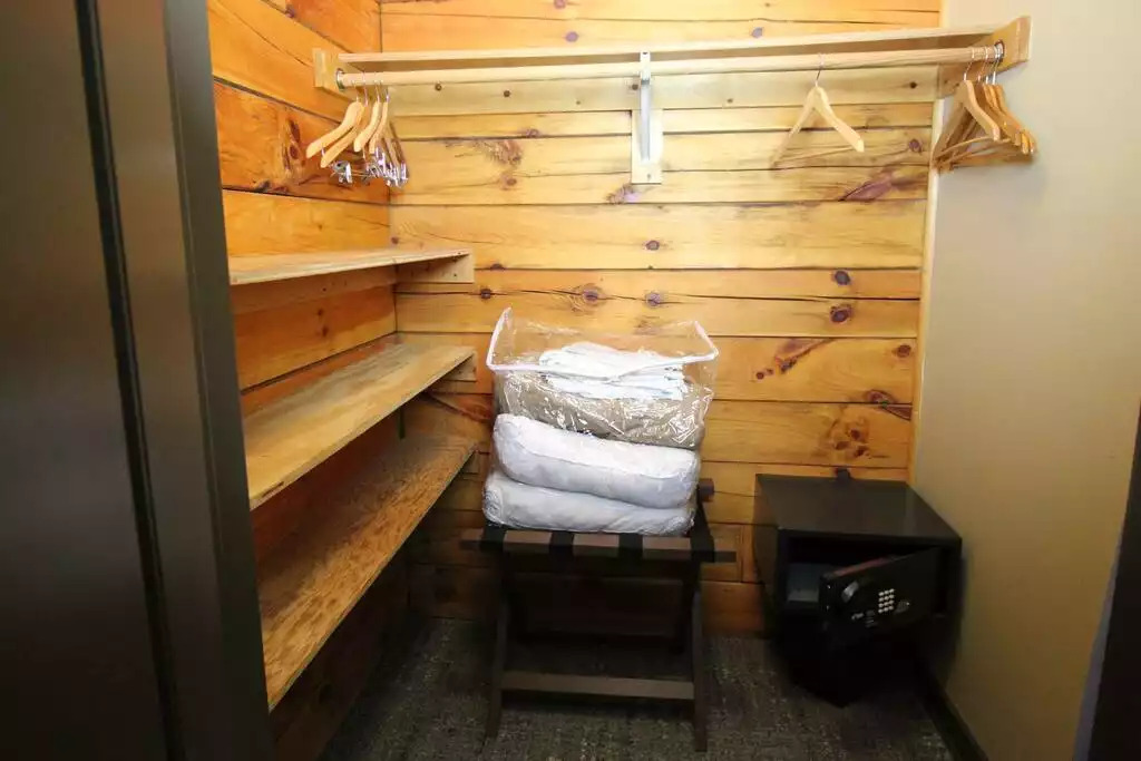 The guest bedroom includes a queen bed and this lovely walk in closet. Closet includes hangers and extra bedding for the sleeper sofa in the living room. A safe is located in every cabin, location of safe may vary. The guest bedroom includes a queen bed and this lovely walk in closet. Closet includes hangers and extra bedding for the sleeper sofa in the living room. A safe is located in every cabin, location of safe may vary. - Entire Cabin 1 Wisc Dells 3 Beds(2Bedrooms) 2Baths - 63 Christmas Mountain Road