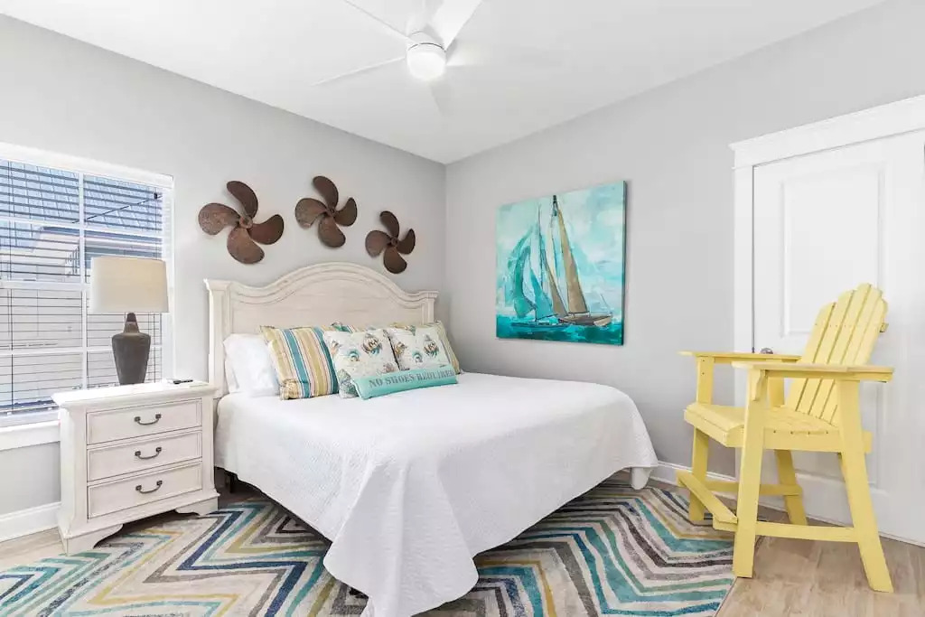 The upstairs boat theme king bedroom has a 50" Smart TV, lifeguard chair, nightstand and walk-in closet. The upstairs boat theme king bedroom has a 50" Smart TV, lifeguard chair, nightstand and walk-in closet. - Shipwrecked Beach House Orange Beach, Alabama - Orange Beach