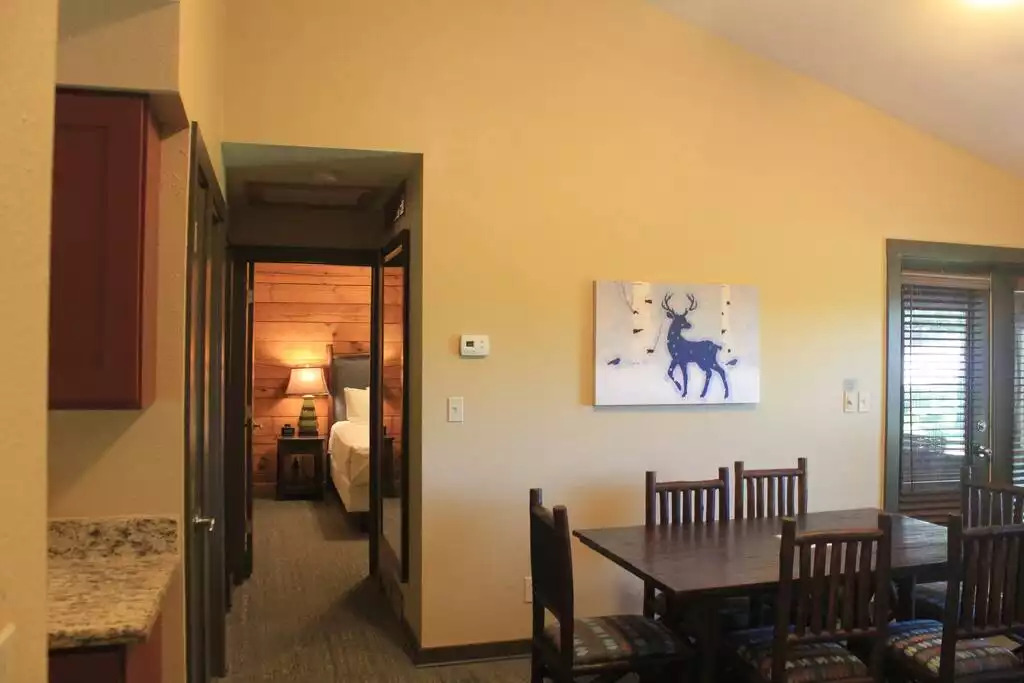 This photo, taken just outside the kitchen, looks straight down into the master bedroom. Bathroom and guest bedroom doors are on our left, along with hall closet. Glimpse into master bedroom at the end of the hall, time to relax after a fun day! This photo, taken just outside the kitchen, looks straight down into the master bedroom. Bathroom and guest bedroom doors are on our left, along with hall closet. Glimpse into master bedroom at the end of the hall, time to relax after a fun day! - Entire Cabin 1 Wisc Dells 3 Beds(2Bedrooms) 2Baths - 63 Christmas Mountain Road