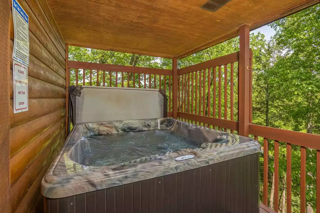 Enjoy the seclusion of this 5-person hot tub and the surrounding beauty of the peaceful wooded area. Enjoy the seclusion of this 5-person hot tub and the surrounding beauty of the peaceful wooded area. - Secluded Luxury 2 Bdrm Cabin w/Theatre Room & Pond - Sevierville