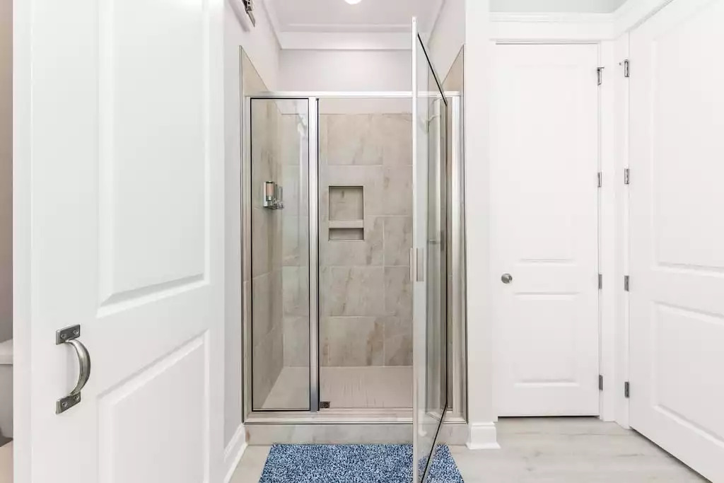 Master en suite bathroom also includes barn door and huge walk-in closet. Shower also has a wall dispenser filled with shampoo, conditioner and body wash. Master en suite bathroom also includes barn door and huge walk-in closet. Shower also has a wall dispenser filled with shampoo, conditioner and body wash. - Shipwrecked Beach House Orange Beach, Alabama - Orange Beach