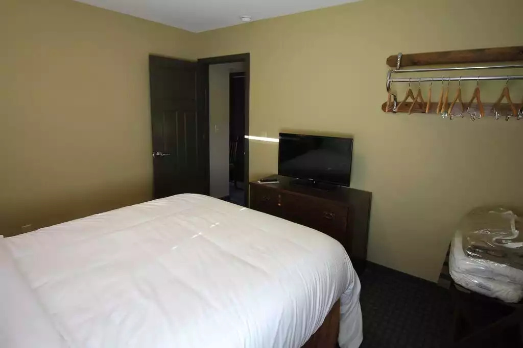 Guest bedroom features queen bed, hanging clothes storage, TV on dresser, two nightstands and clock radio. Shown in plastic bag is bedding for the pull out sleeper sofa in the living room. Even that bed is comfortable! Guest bedroom features queen bed, hanging clothes storage, TV on dresser, two nightstands and clock radio. Shown in plastic bag is bedding for the pull out sleeper sofa in the living room. Even that bed is comfortable! - Entire Cottage 1 Wisc Dells 2 Bed 1 Bath Sleeps 6 - Wisconsin Dells