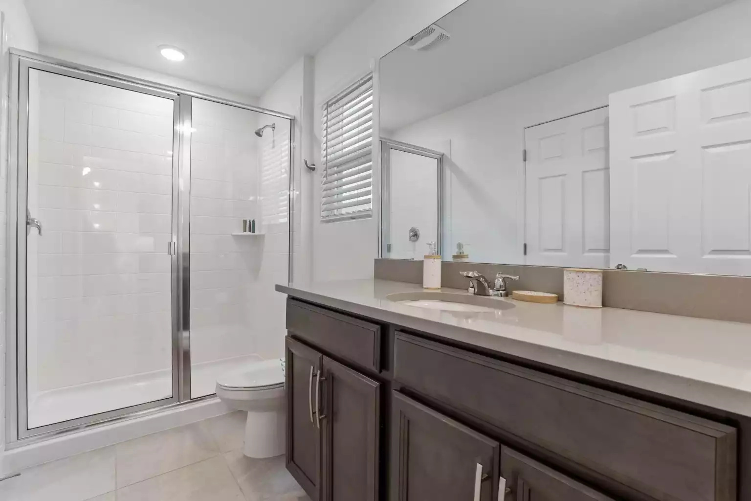 Full bathroom with walk in shower, large mirror and vanity. Full bathroom with walk in shower, large mirror and vanity. - Luxury Vacation Home Minutes From Disney World - Kissimmee