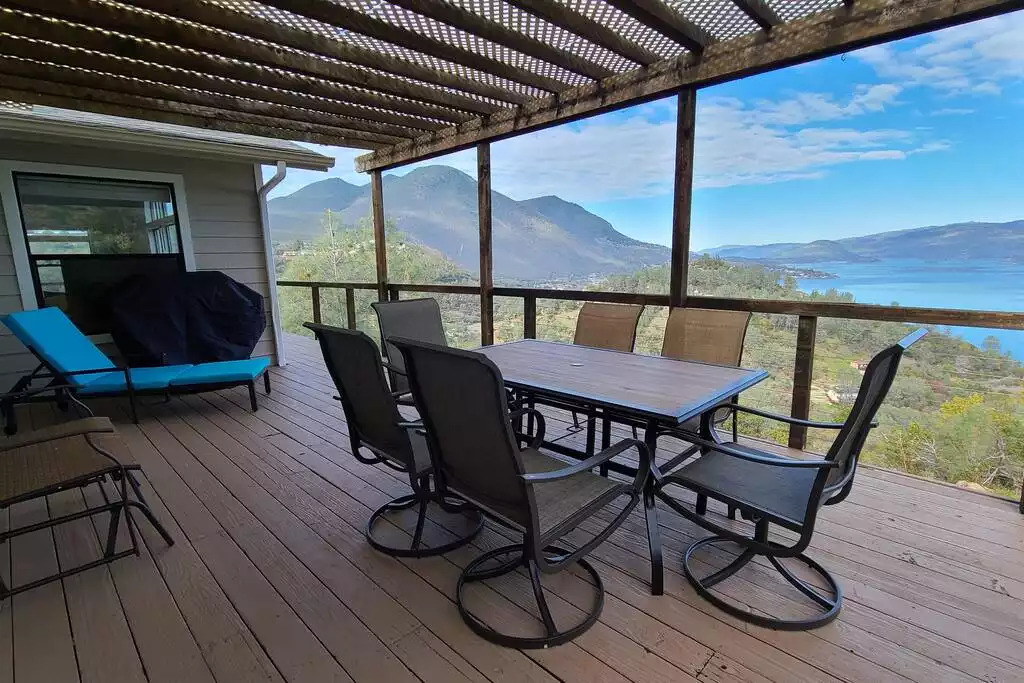 Relax in a wrap around deck with serene lake and Mt. Konocti view equipped with a grill, 6 seater dining table, a mini swing and a lounge chair. Relax in a wrap around deck with serene lake and Mt. Konocti view equipped with a grill, 6 seater dining table, a mini swing and a lounge chair. - NEW Unobstructed Lake/Mountain View home, movie rm - Kelseyville