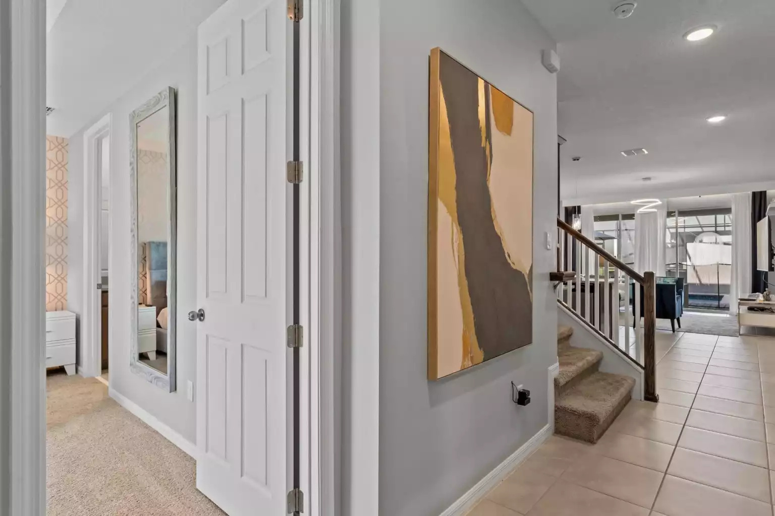 Large wall painting in entryway next to stairway leading to the second floor. Large wall painting in entryway next to stairway leading to the second floor. - Luxury Vacation Home Minutes From Disney World - Kissimmee