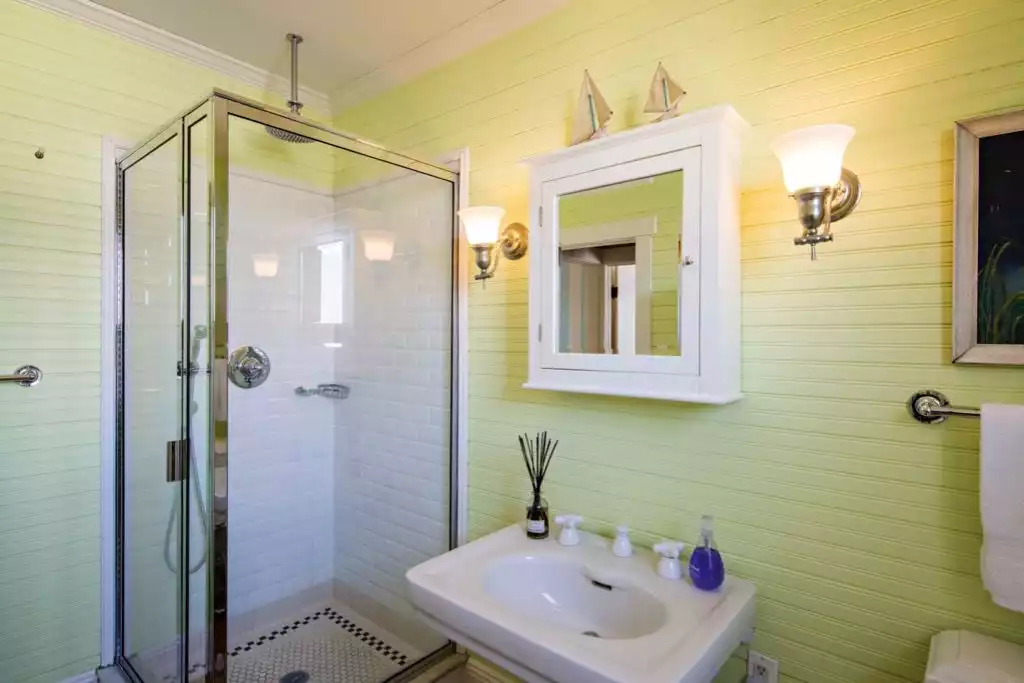 Chadwick Cottage Vacation Rental Home. Rear bathroom with bead board walls, vintage pedestal sink and shower with subway tile. Vacation Rentals Asbury Park. Vacation Rentals Ocean Grove. Chadwick Cottage Vacation Rental Home. Rear bathroom with bead board walls, vintage pedestal sink and shower with subway tile. Vacation Rentals Asbury Park. Vacation Rentals Ocean Grove. - Chadwick Cottage Vacation Rental Home - Ocean Grove