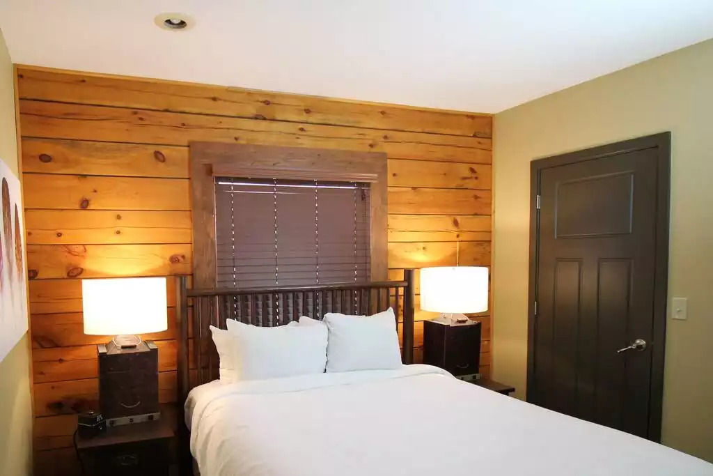 This guest bedroom contains a queen bed, walk in closet, a safe to protect your valuables, and a TV mounted on wall with free cable. Bedroom also includes clock radio. The luxury, comfortable beds will have you sleeping like a baby! This guest bedroom contains a queen bed, walk in closet, a safe to protect your valuables, and a TV mounted on wall with free cable. Bedroom also includes clock radio. The luxury, comfortable beds will have you sleeping like a baby! - Entire Cabin 1 Wisc Dells 3 Beds(2Bedrooms) 2Baths - 63 Christmas Mountain Road
