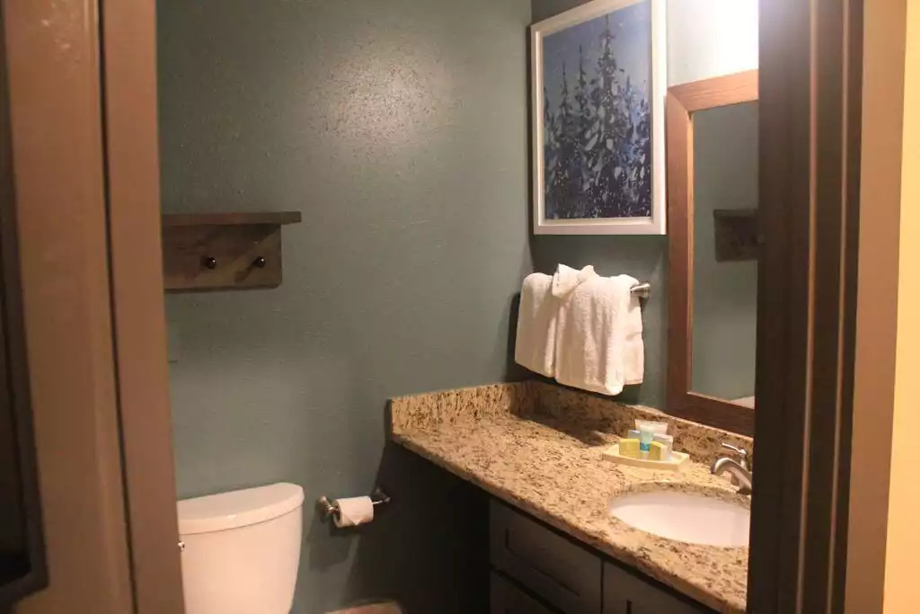 This cozy master bath includes a vanity cabinet for storage, granite countertop, magnified makeup mirror, gorgeous tile floors and tub surround. Privately located off the master bedroom. This cozy master bath includes a vanity cabinet for storage, granite countertop, magnified makeup mirror, gorgeous tile floors and tub surround. Privately located off the master bedroom. - Entire Cabin 3 Wisc Dells 3 Beds(2Bedrooms) 2Baths - Wisconsin Dells