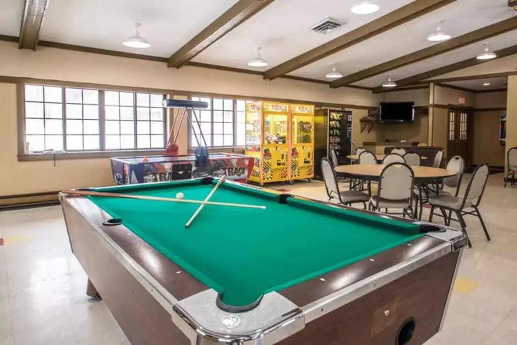 This activities building, right next to the largest pool, includes game room, free air hockey and ping pong. Adjacent to additional charcoal grills under pergola, basketball court, tennis court, shuffle board, and children's play area. This activities building, right next to the largest pool, includes game room, free air hockey and ping pong. Adjacent to additional charcoal grills under pergola, basketball court, tennis court, shuffle board, and children's play area. - Entire Cabin 1 Wisc Dells 3 Beds(2Bedrooms) 2Baths - 63 Christmas Mountain Road