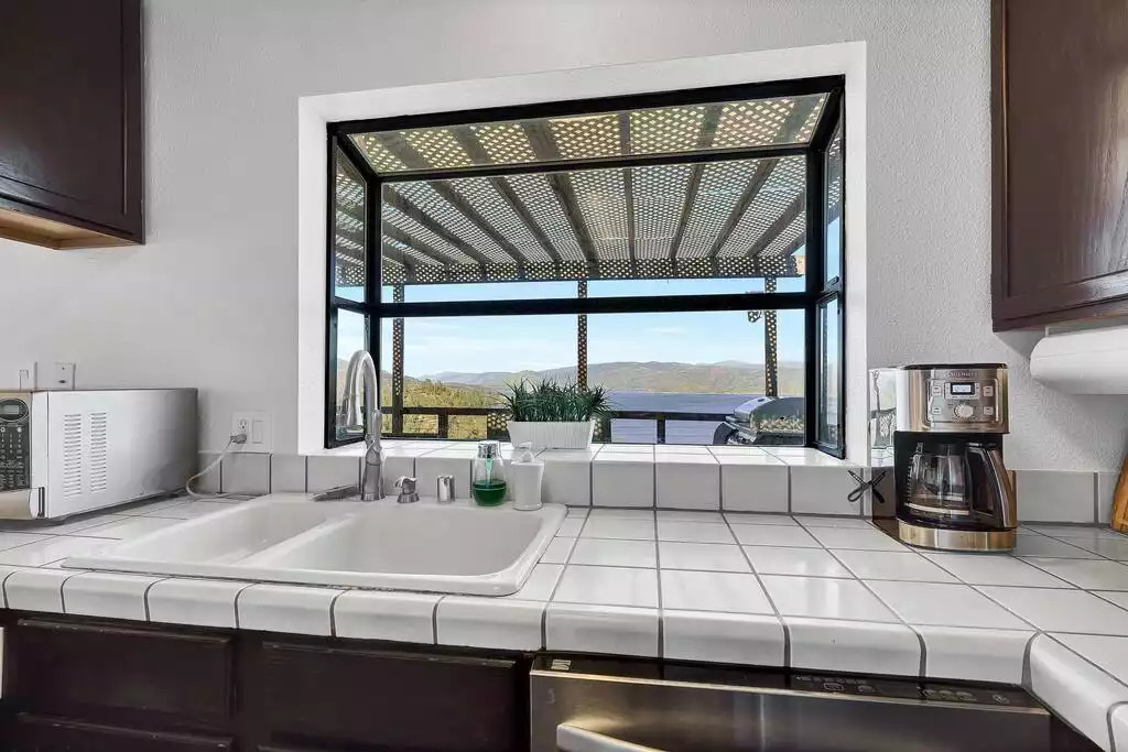 Kitchen with a view of the Lake and surrounding mountains Kitchen with a view of the Lake and surrounding mountains - NEW Unobstructed Lake/Mountain View home, movie rm - Kelseyville