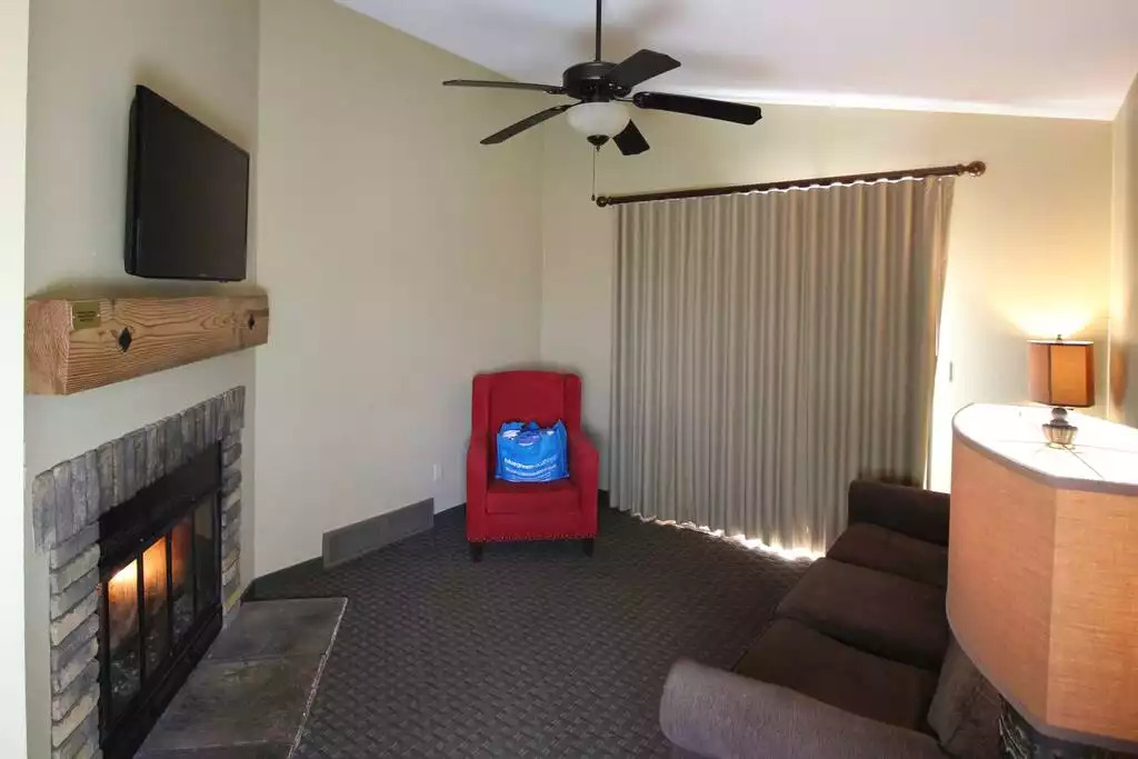 The glow of the fireplace will make every evening relaxing! This living room of the cottage contains vaulted ceilings, fireplace (some gas, some wood), pull out sofa sleeper, and wing back chair. A wonderful room to relax in after a day of fun! The glow of the fireplace will make every evening relaxing! This living room of the cottage contains vaulted ceilings, fireplace (some gas, some wood), pull out sofa sleeper, and wing back chair. A wonderful room to relax in after a day of fun! - Entire Cottage 1 Wisc Dells 2 Bed 1 Bath Sleeps 6 - Wisconsin Dells