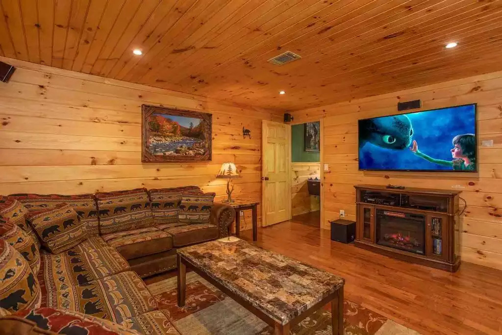 Theatre room with 65” tv and electric fireplace Theatre room with 65” tv and electric fireplace - Secluded Luxury 2 Bdrm Cabin w/Theatre Room & Pond - Sevierville