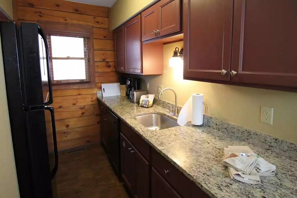 A full, galley style kitchen, including full sized refrigerator with ice maker, full sized stove/oven and microwave. This equipped kitchen includes utensils, dishes, glasses for six guests as well as cookware, blender, toaster, towels and dish soap. A full, galley style kitchen, including full sized refrigerator with ice maker, full sized stove/oven and microwave. This equipped kitchen includes utensils, dishes, glasses for six guests as well as cookware, blender, toaster, towels and dish soap. - Entire Cabin 1 Wisc Dells 3 Beds(2Bedrooms) 2Baths - 63 Christmas Mountain Road