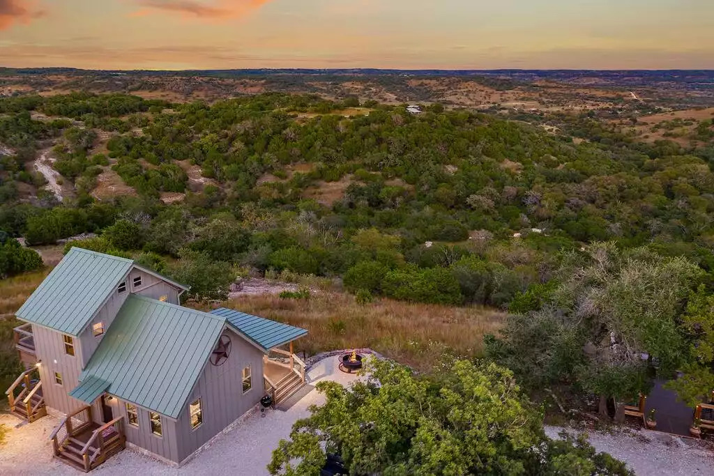Aerial view/cabin on 57 private acres over looking an endless view. Many trails through/out the property to enjoy exploring and hiking and driving the mule. Terrain is steep in areas. Most rent the mule as it can be taxing walking back up the hill.