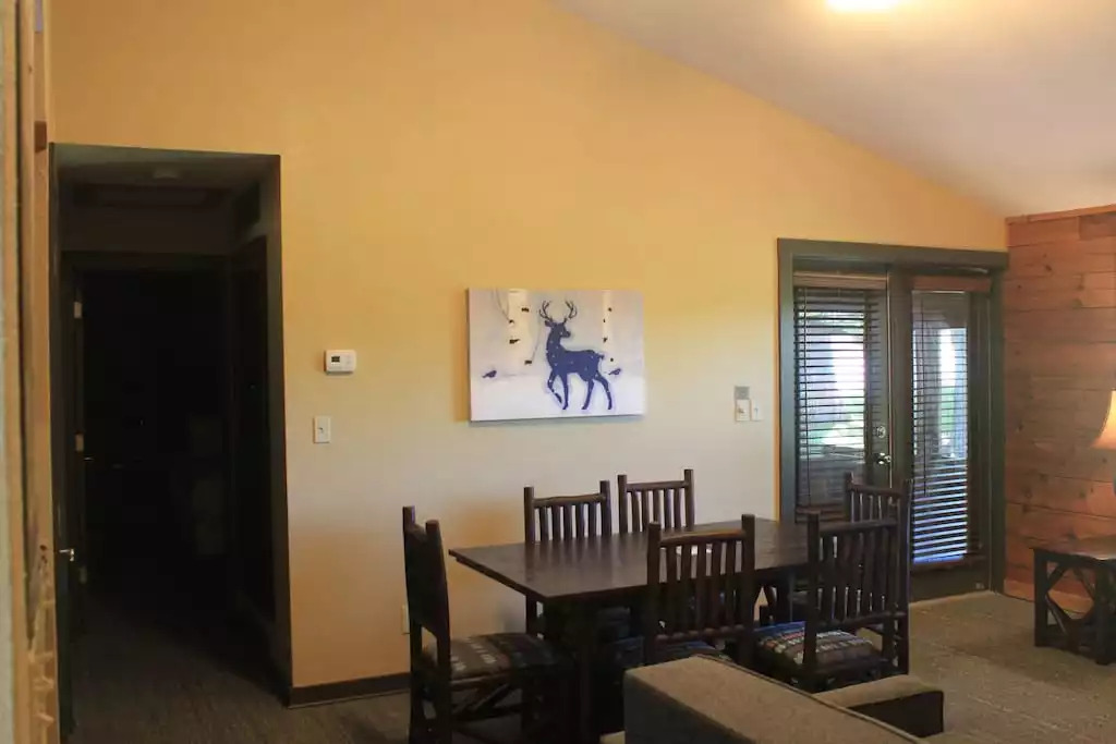 The dining table is perfect for dinners in, or a workspace, for catching up on emails. This open concept living and dining area lends itself to quality family time. To the left a hallway to the bedrooms. To the right, your screened in porch. The dining table is perfect for dinners in, or a workspace, for catching up on emails. This open concept living and dining area lends itself to quality family time. To the left a hallway to the bedrooms. To the right, your screened in porch. - Entire Cabin 3 Wisc Dells 3 Beds(2Bedrooms) 2Baths - Wisconsin Dells