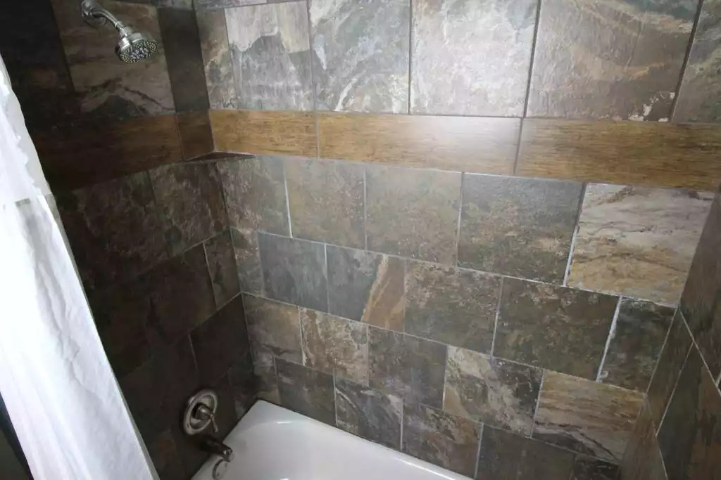 Private bathroom adjoining master bedroom includes tub/shower combination. Beautiful tile walls in bath/shower add to the luxury feeling of My Friends Cabin. Vaulted ceilings from bedroom continue in adjoining bathroom. Book now to relax here! Private bathroom adjoining master bedroom includes tub/shower combination. Beautiful tile walls in bath/shower add to the luxury feeling of My Friends Cabin. Vaulted ceilings from bedroom continue in adjoining bathroom. Book now to relax here! - Entire Cabin 1 Wisc Dells 3 Beds(2Bedrooms) 2Baths - 63 Christmas Mountain Road