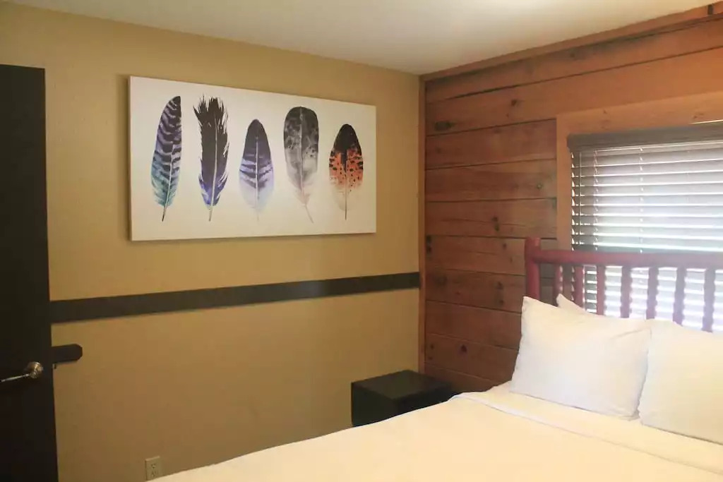 This bedroom contains a queen bed, walk in closet, dresser, a safe to protect your valuables, and a TV with cable. This bedroom contains a queen bed, walk in closet, dresser, a safe to protect your valuables, and a TV with cable. - Entire Cabin 3 Wisc Dells 3 Beds(2Bedrooms) 2Baths - Wisconsin Dells