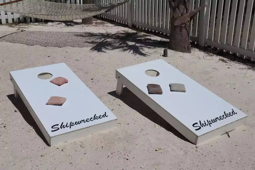 Keep score if you want to while you play a game of "Shipwrecked" corn hole in the private fenced in sandy backyard that also backs up to a canal of water. This area is such a great area for backyard cookouts & relaxing! Keep score if you want to while you play a game of "Shipwrecked" corn hole in the private fenced in sandy backyard that also backs up to a canal of water. This area is such a great area for backyard cookouts & relaxing! - Shipwrecked Beach House Orange Beach, Alabama - Orange Beach