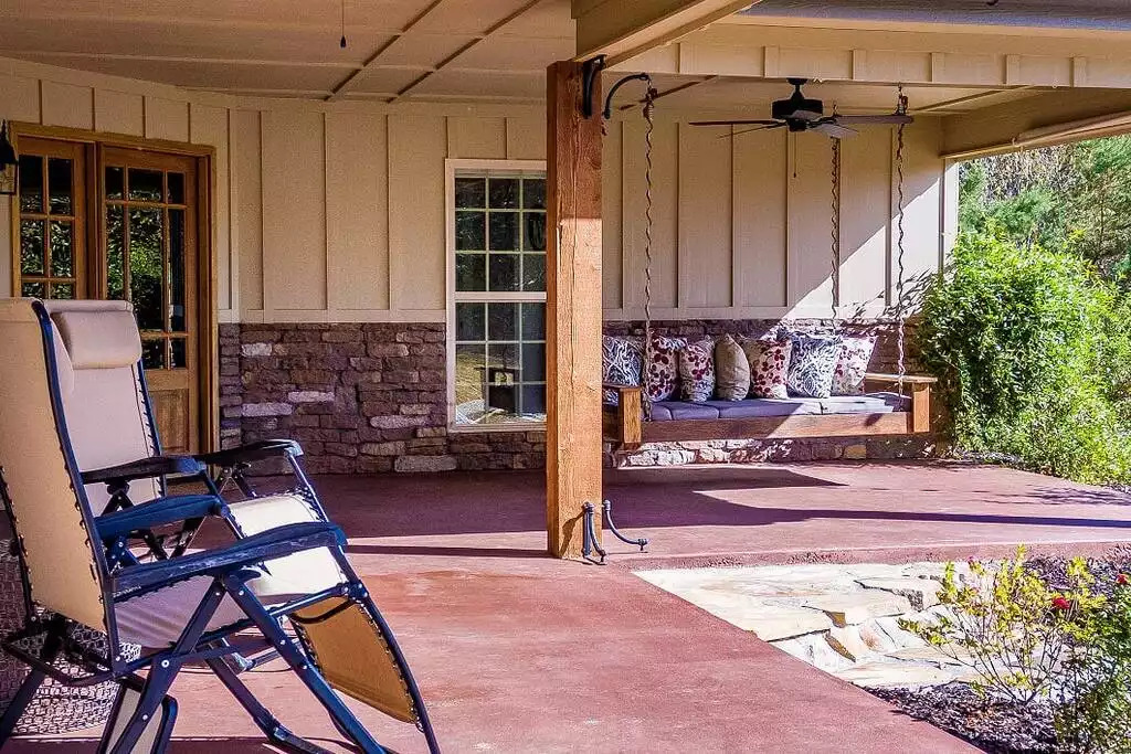 The porch swing can accommodate two people easily. It's the perfect spot for reading a book. Weight limit-500 lbs. The porch swing can accommodate two people easily. It's the perfect spot for reading a book. Weight limit-500 lbs. - Fox View Cottage - Rising Fawn
