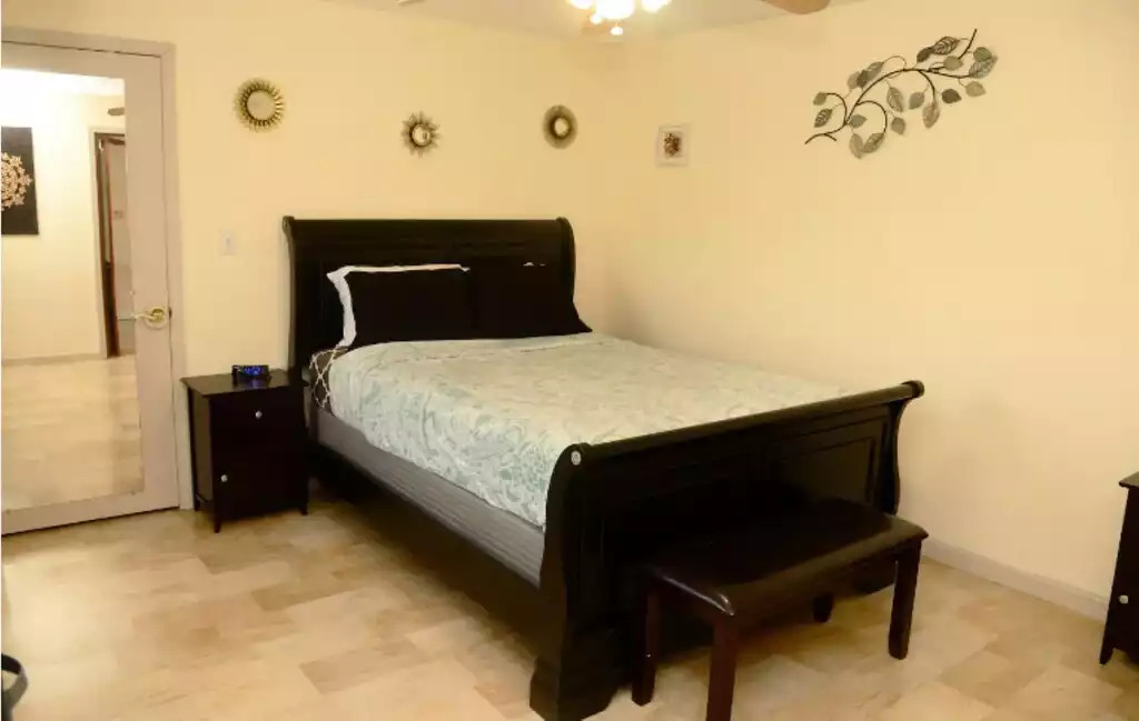 Master bedroom has a queen bed, 35 inch smart TV, and large walk in closet. Master bedroom has a queen bed, 35 inch smart TV, and large walk in closet. - Legacy Lake House - Kingsley