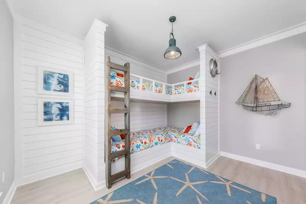 A kid’s dream comes true in this ocean themed bunk room with nautical lighting, porthole & ocean themed bedding! The room has 4 twin beds, storage console, 50” Smart TV & DVD player. Kids will “seas the moment” on their vacation with “Shipwrecked”! A kid’s dream comes true in this ocean themed bunk room with nautical lighting, porthole & ocean themed bedding! The room has 4 twin beds, storage console, 50” Smart TV & DVD player. Kids will “seas the moment” on their vacation with “Shipwrecked”! - Shipwrecked Beach House Orange Beach, Alabama - Orange Beach