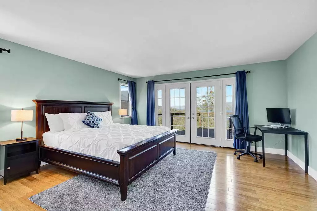Primary (master) bedroom with King Bed, dedicated computer desk/chair, private bath, walk-in closet, access to wrap around deck and a splendid view of the Clear Lake and MT. Konocti. Primary (master) bedroom with King Bed, dedicated computer desk/chair, private bath, walk-in closet, access to wrap around deck and a splendid view of the Clear Lake and MT. Konocti. - NEW Unobstructed Lake/Mountain View home, movie rm - Kelseyville