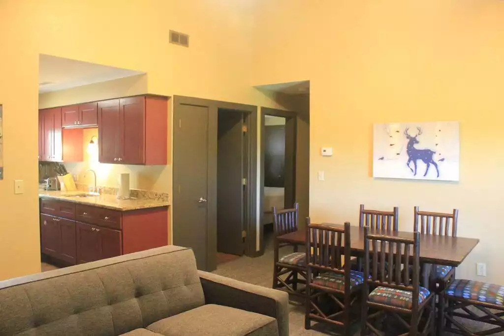 With the galley kitchen open to the dining and living areas, snacks for movie night are readily available. Don't forget to turn on your fireplace to add to the ambiance. Also shown in this photo is hall closet, door to bathroom and bedroom. With the galley kitchen open to the dining and living areas, snacks for movie night are readily available. Don't forget to turn on your fireplace to add to the ambiance. Also shown in this photo is hall closet, door to bathroom and bedroom. - Entire Cabin 3 Wisc Dells 3 Beds(2Bedrooms) 2Baths - Wisconsin Dells