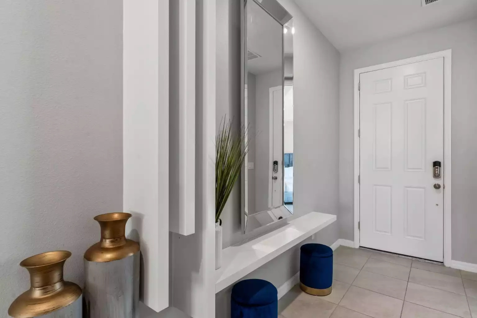Entryway with modern mirror and tile floor. Entryway with modern mirror and tile floor. - Luxury Vacation Home Minutes From Disney World - Kissimmee