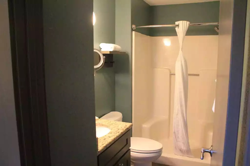 This bath includes shower stall, granite countertop, magnified make up mirror, and vanity storage. The cabin includes 6 bath towels, hand towels and wash cloths. Hair dryer, soap, shampoo and conditioner included. This bath includes shower stall, granite countertop, magnified make up mirror, and vanity storage. The cabin includes 6 bath towels, hand towels and wash cloths. Hair dryer, soap, shampoo and conditioner included. - Entire Cabin 3 Wisc Dells 3 Beds(2Bedrooms) 2Baths - Wisconsin Dells