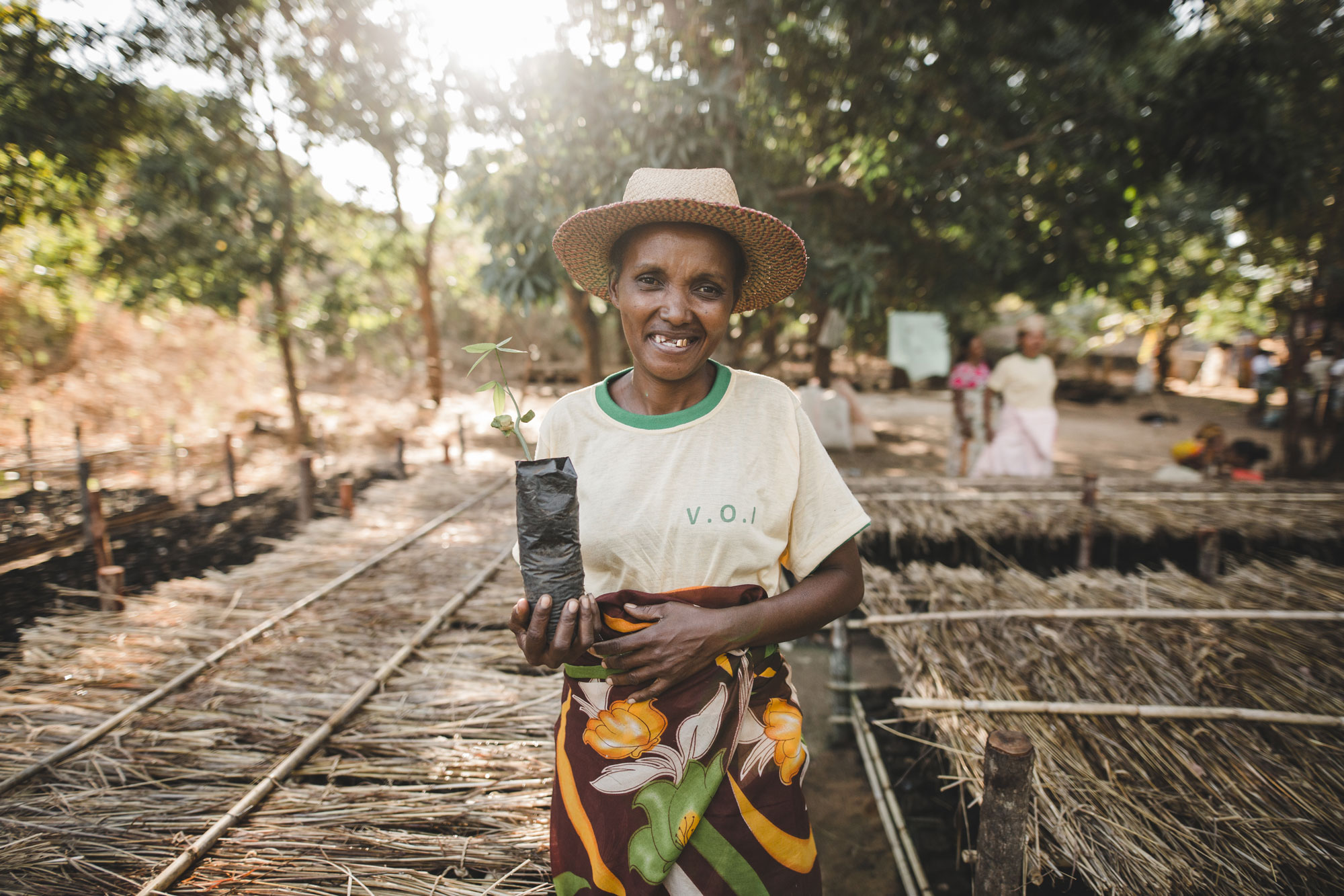 woman holding seedling in nursery