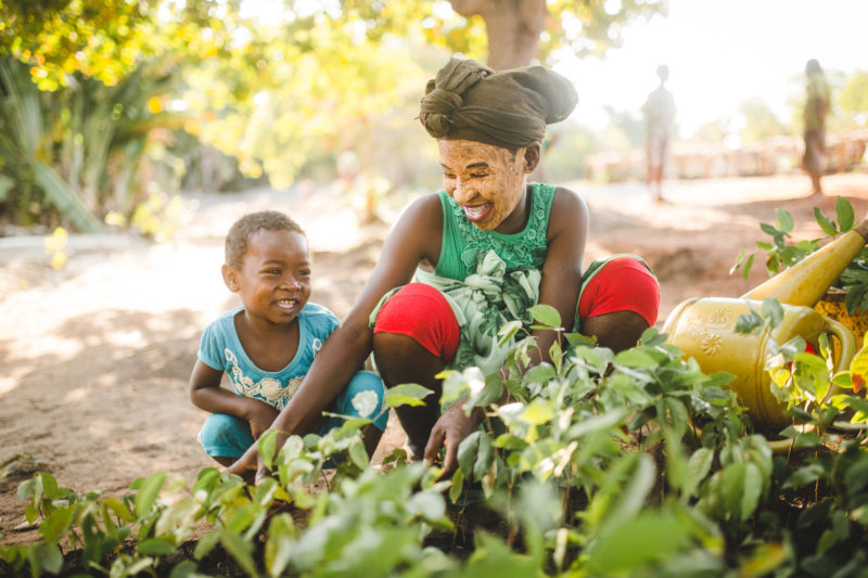 kids smiling with seedlings