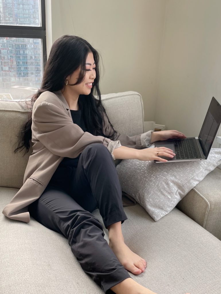 Woman sitting on couch with laptop
