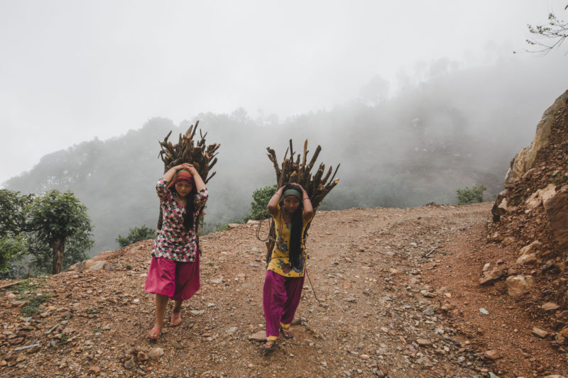 women walking with firewood]