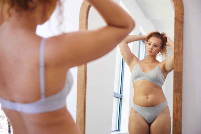 woman looking in mirror